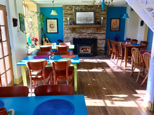 Interior of the Canal House dining area with a fire in the fireplace